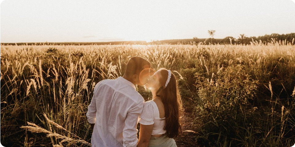 two people happily in love, in a field. Being able to be open with loved ones is an important step in emotional balance.