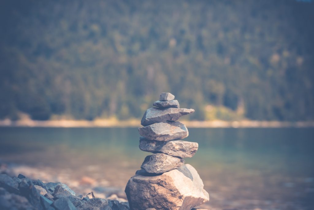 pile of rocks near a lake. Representing the emotional balance we all want and need